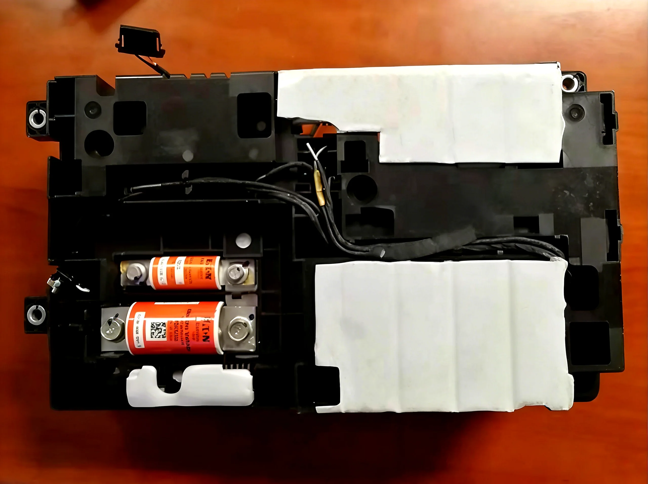 Thermal pad placement inside EV battery disconnect unit